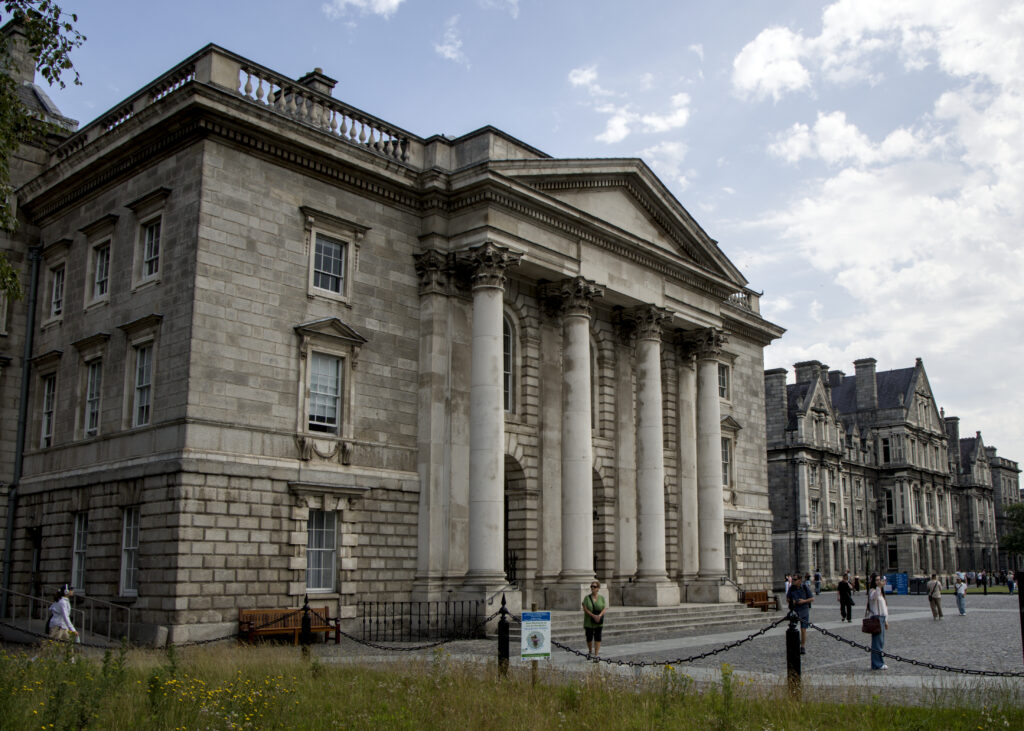A big stone building with columns on the front