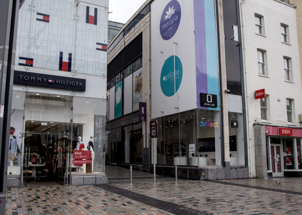 A Tommy Hilfiger store next to a phone store
